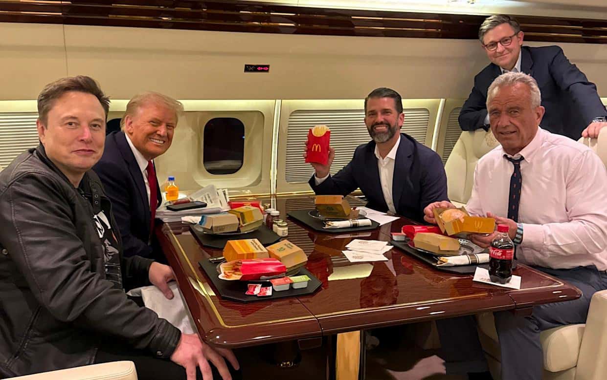 Donald Trump, Elon Musk, Robert F. Kennedy Jr., and team sharing a meal on a private jet